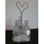 A 19th century silver-plated decanter stand with three cut-glass decanters with mushroom stoppers;