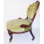 A late 19th century nursing chair; carved mahogany frame and green upholstery, for restoration