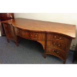 A large late 18th century serpentine-fronted mahogany and cross-banded sideboard; central bow-