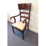 A late Regency period mahogany open armchair; the unusually large concave tablet-shaped figured