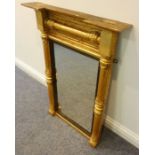 An early 19th century giltwood pier glass; two outset corners above a tablet frieze with split