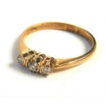 A gold three-stone diamond ring (The cost of UK postage via Royal Mail Special Delivery for this lot