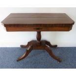 A Regency period mahogany fold-over top card table; turned stem platform base and four downswept
