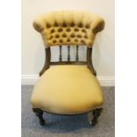 A late 19th century Aesthetic style ebonised, gilt-highlighted and button-back low chair raised on