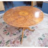 An unusual 19th century circular-topped figured walnut occasional table; turned stem and on tripod