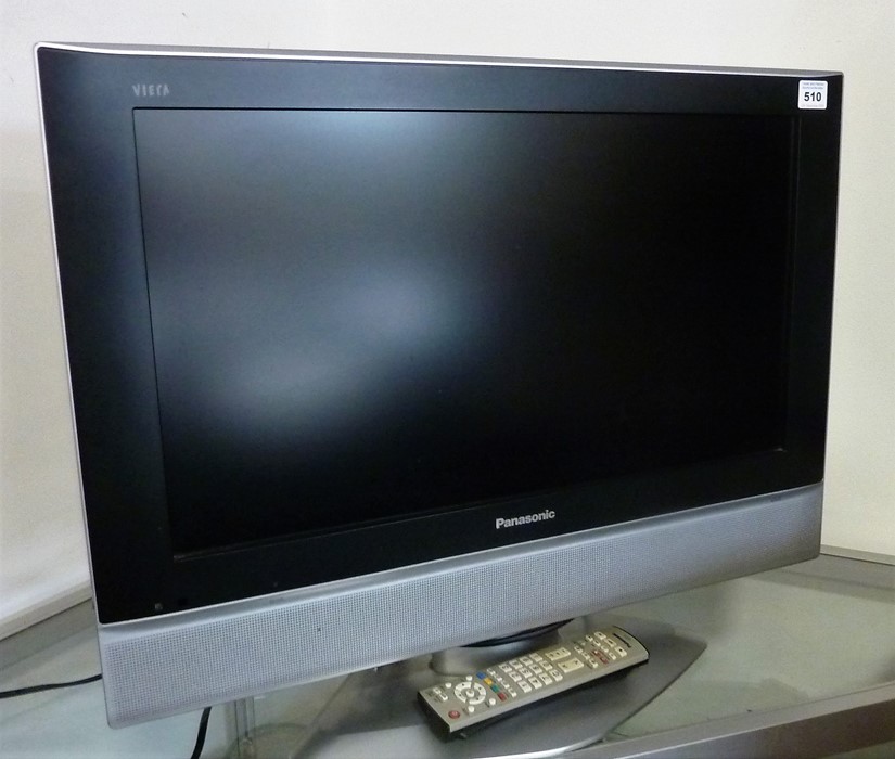 A flat-screen television with remote control (23")