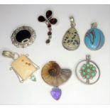 A good selection of various pendants/brooches etc. mostly mounted with hardstones