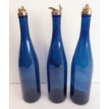 A set of three Bristol-blue wine decanters, each with silver-plated mounts