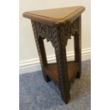 An unusual 19th century triangular oak occasional table; the moulded top above three friezes