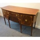 An early 19th century English bow-fronted mahogany and satinwood cross banded sideboard of small and