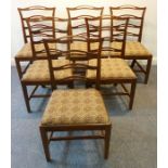 A set of six George III period pierced ladderback mahogany chairs; drop-in seats and square tapering