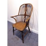 A mid-19th century comb-back Windsor chair; wheel-back splat, ash bow-shaped elm seat, turned