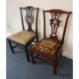 Two Chippendale-style mahogany dining chairs; each with carved top rail, pierced splats, later