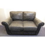 A modern two-seater sofa upholstered in gun-metal leather (149cm wide x 96cm deep)