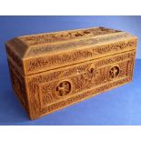 An antique Asian carved hardwood box decorated with dancing figures and fine floral scrolls (12.