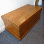 An early 20th century waxed pine trunk on plinth base having exposed dovetails (113.5 widest x