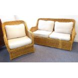 A conservatory-style two-seater wickerwork sofa with cushions, together with matching armchair