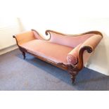 A late Regency period faded pink velour upholstered and rosewood chaise longue finely carved with