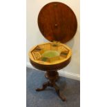 A mid-19th century circular walnut work table; the quarter-veneered figured top with foliate