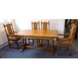 A good extending oak kitchen-style dining table with four chairs; the table with two end