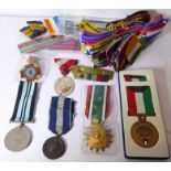 An assortment of six medals together with a large collection of medal ribbons: the Greek