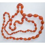 A string of Art Deco period graduated glass beads, circa 1930s (total length 109cm) (The cost of