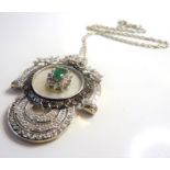 An 18-carat white-gold pendant set with champagne diamonds, white diamonds and a central emerald (