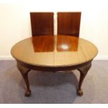 An early 20th century extending mahogany dining table having two extra leaves; gadrooned edge and