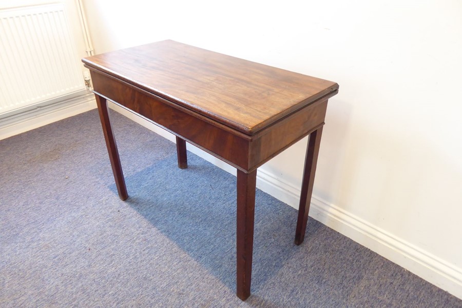 A George III period fold-over top mahogany card table raised on square chamfered legs (90.5cm wide)