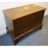 A late 18th/early 19th century oak chest; the two-plank cleated top with original strap hinges above