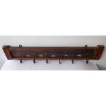 An early 20th century rustic painted wood coat hanger with six blacksmith-made iron hooks (77.5cm