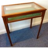 A mahogany and glass-sided bijouterie cabinet; hinged top above four square-section chamfered