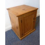 An early 20th century pine cupboard of small proportions; single panelled door on plinth base (50.