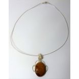A silver-mounted cabochon hardstone pendant upon a silver torque (The cost of UK postage via Royal