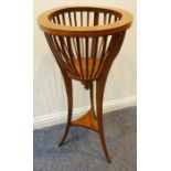 A circular mahogany and satinwood-crossbanded jardiniere stand raised on square tapering boxwood-