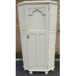 A cream-painted shabby-chic-style wardrobe; the central panelled door with linenfold panelling below