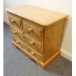 A modern pine bedroom-style chest; moulded top above two half-width and two full-width drawers,