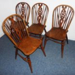 A set of four mid-19th century wheelback chairs of good colour; each with ash bow-shaped elm seat