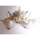 A heavy Art Deco period hallmarked silver three-piece tea service, the teapot with ivory handle