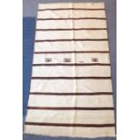 A modern cream and brown striped rug (275cm x146cm)