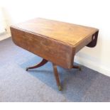 An early 19th century mahogany Pembroke table; two drop leaves above single flush end drawer and