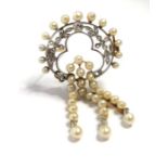 An Edwardian pearl and diamond-set brooch, of openwork design; the floral and foliate diamond-set