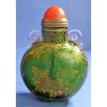 An 18th century Chinese green-glass snuff bottle with gilt-metal spoon, decorated with gilt