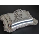 A very large and heavy solid silver entrée dish in Georgian style, the heavily cast handle