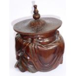 A late 19th/early 20th century Chinese hardwood tobacco jar carved in the shape of a cloaked