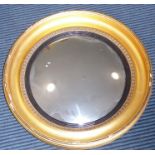An early 19th century circular gilt-framed bullseye mirror having convex plate exhibiting some