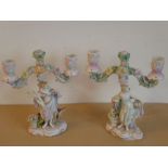 An interesting pair of 19th century hand-decorated continental porcelain two-light candelabra;