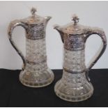 A very fine pair of early 20th century hand-cut glass and silver-mounted claret jugs; each hinged