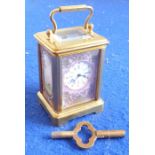 A novelty miniature gilt-metal and porcelain-mounted carriage clock; white-enamel dial with Roman