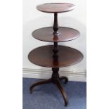 An early 19th century three-tier circular mahogany dumb waiter, turned stem and on three downswept